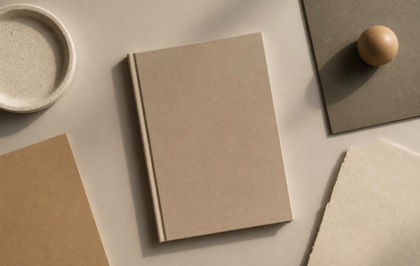 Neutral desk surface with a plain notebook